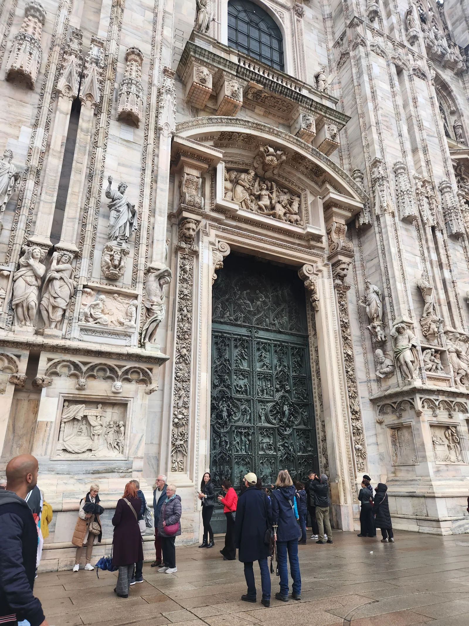 The grand bronze doors of the Milan Duomo