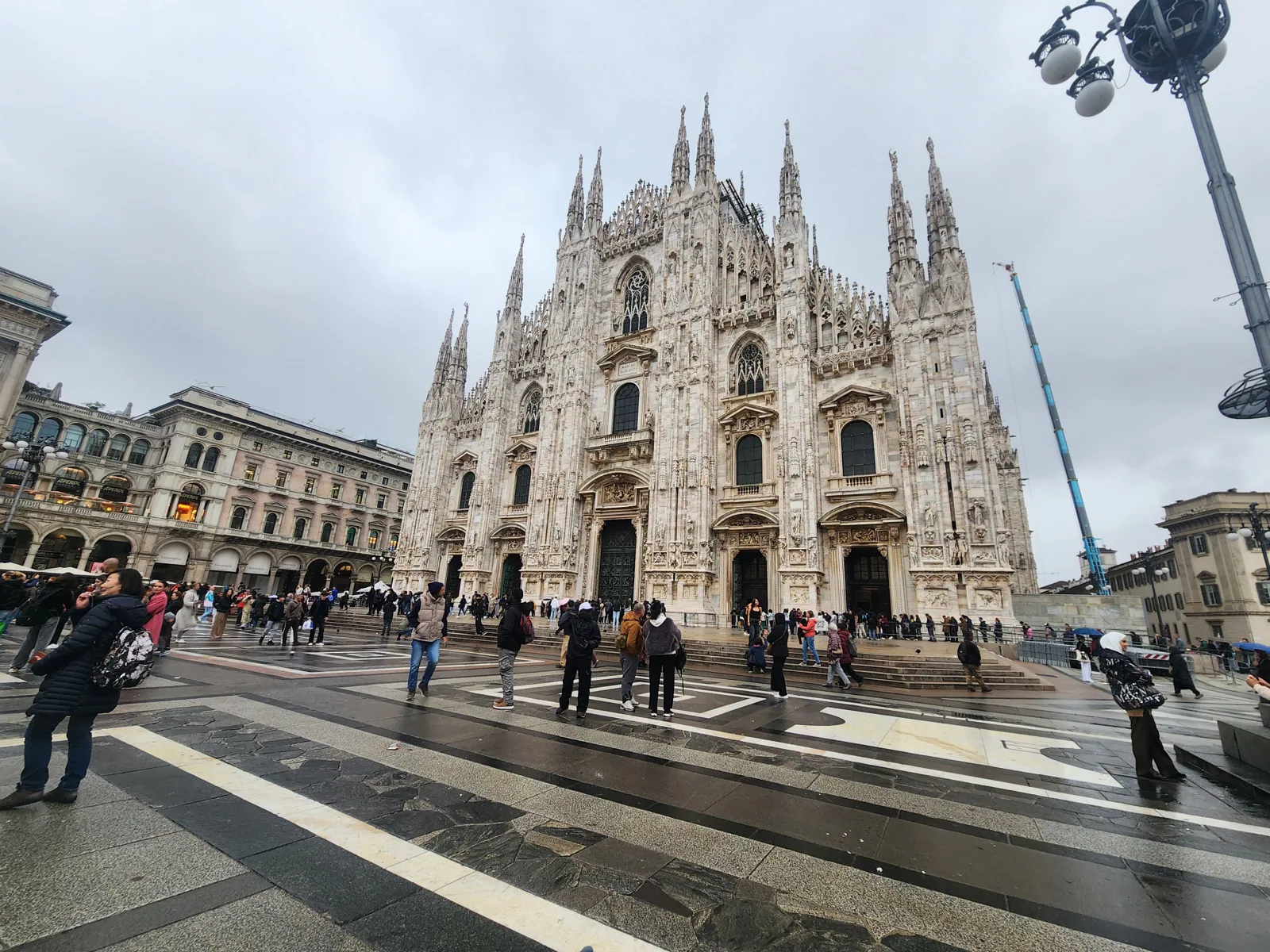The Milan Duomo cathedral under a grey autumn sky
