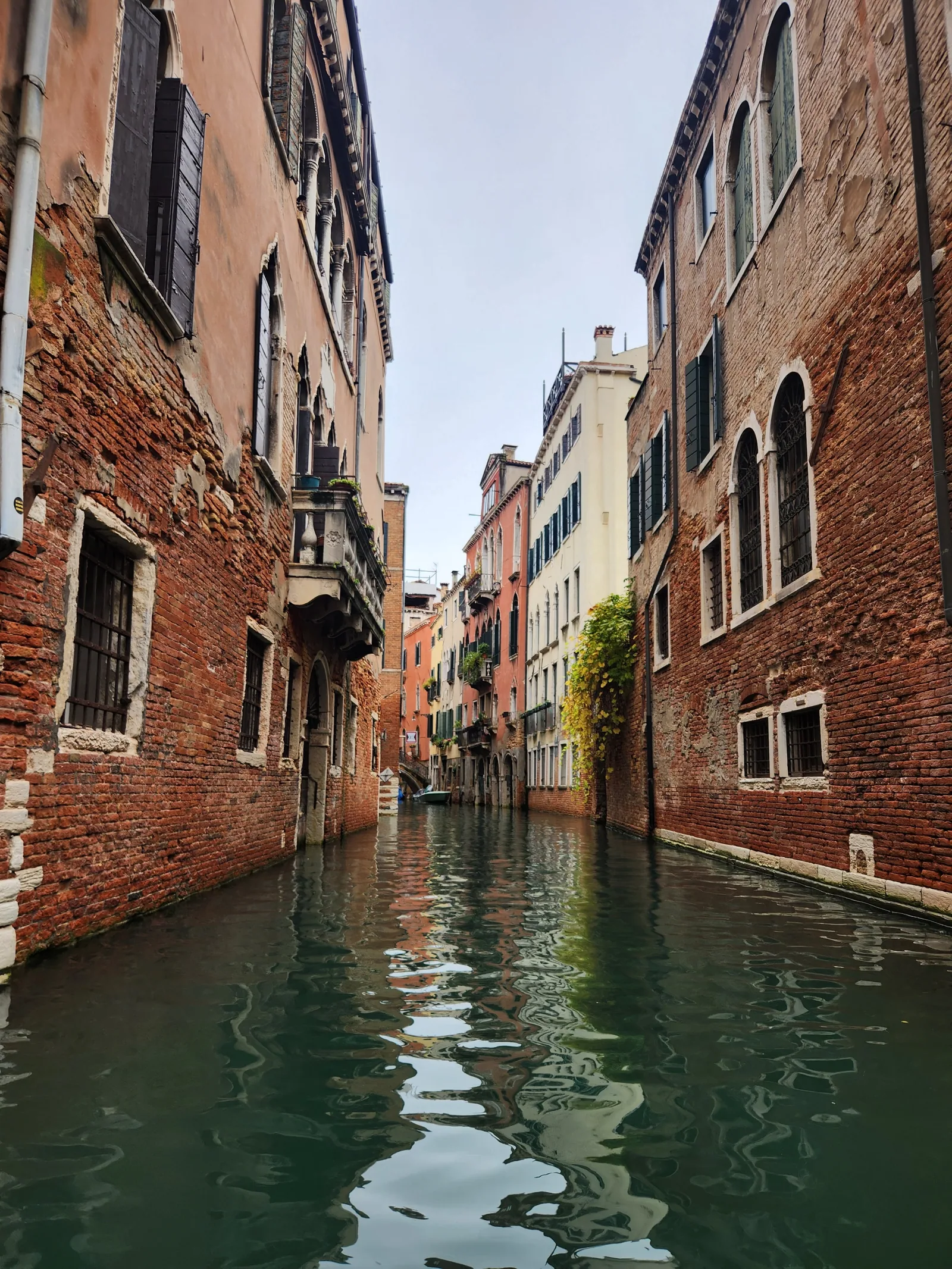 View from a gondola down a narrow canal in Venice