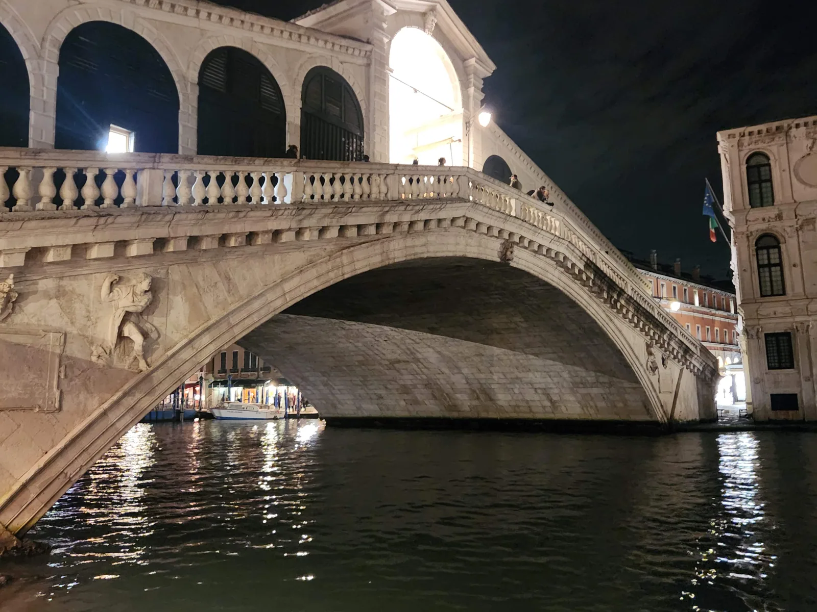 The Rialto Bridge floodlit at night in Venice