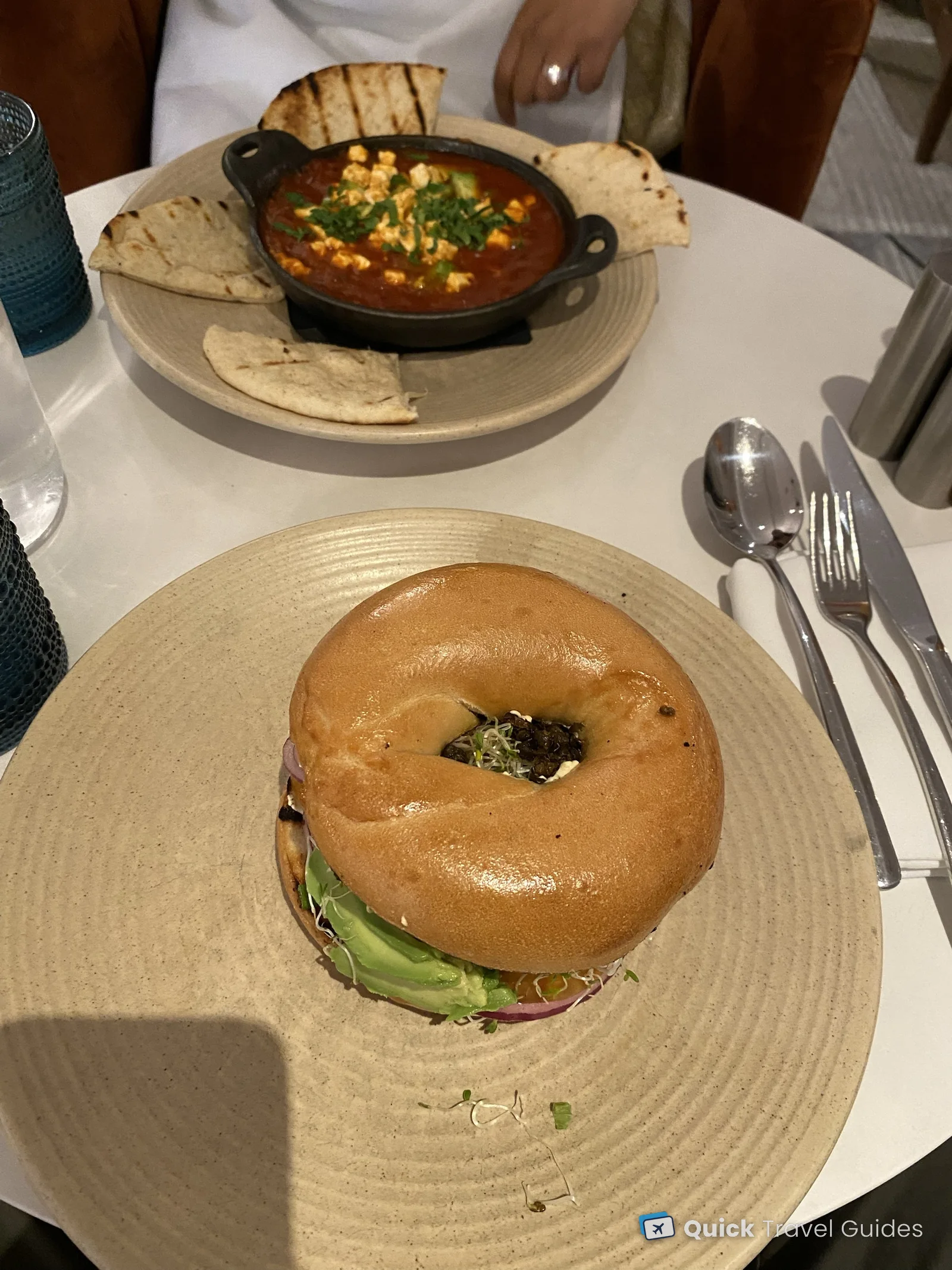 Breakfast for two at the Kimpton Canary in Santa Barbara: an avocado bagel and a vegetarian shakshuka with pita
