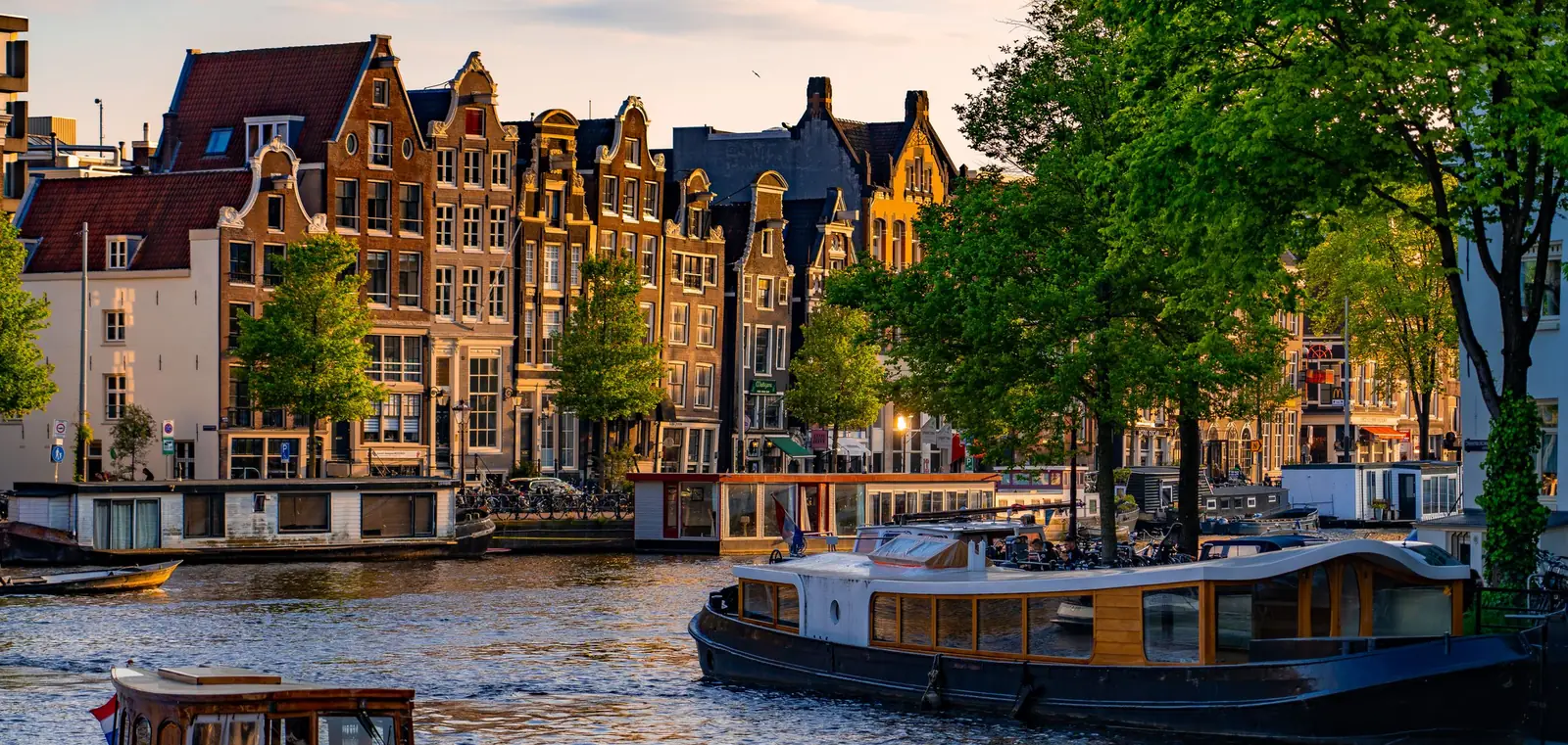 Canal houses and moored boats along a canal in Amsterdam